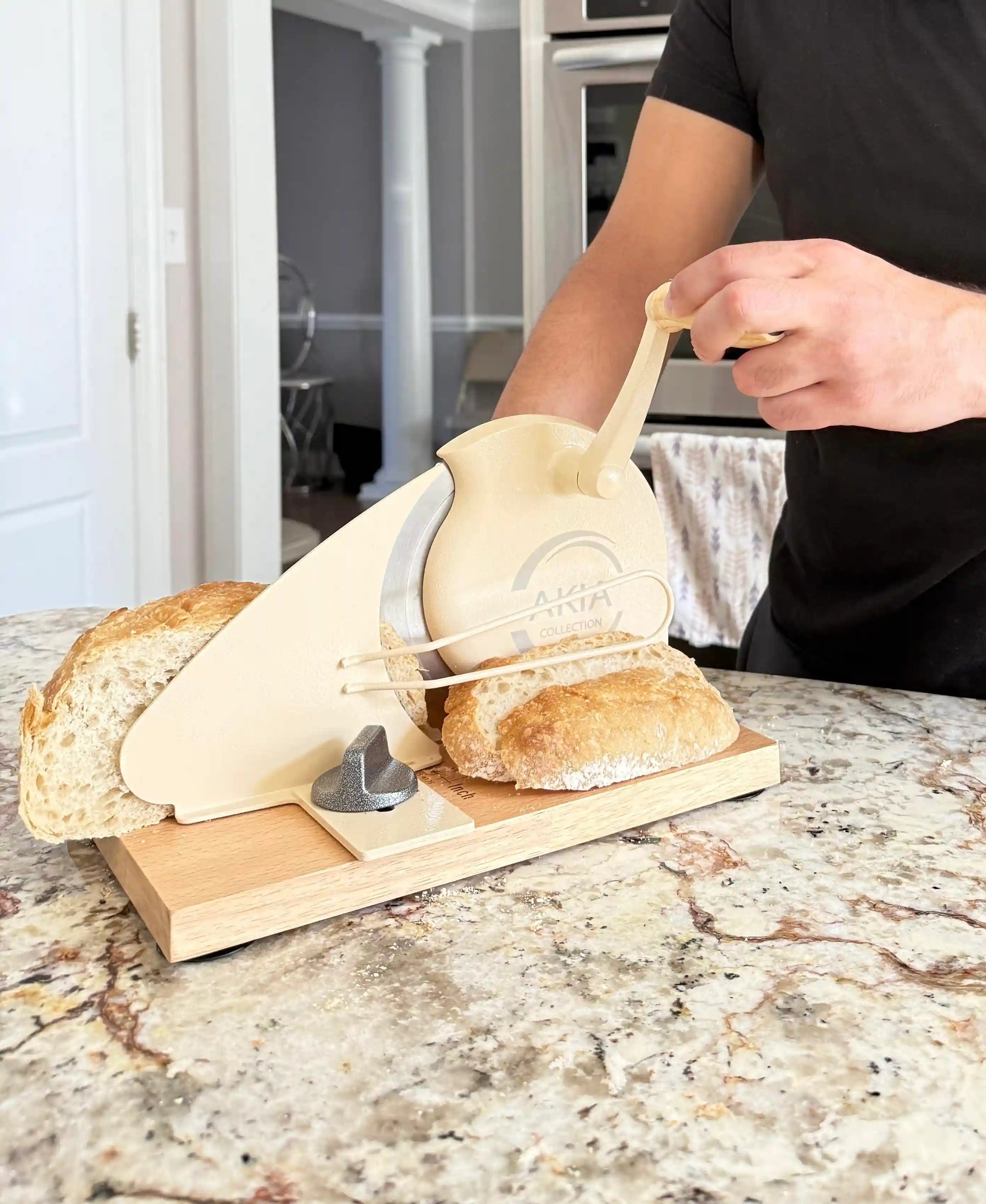 Slicing homemade bread with Akia Collection manual hand crank bread slicer